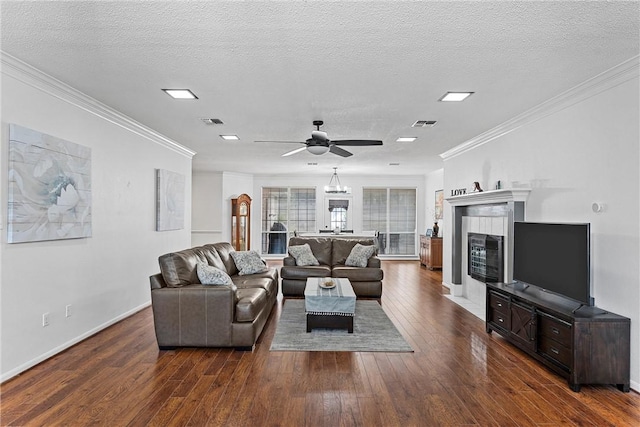 living room featuring a textured ceiling, crown molding, and dark wood-type flooring