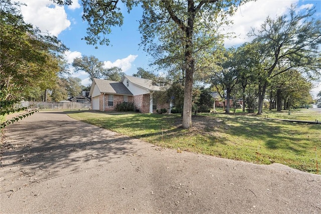 view of front of property featuring a front yard and a garage