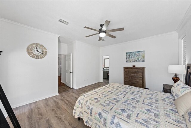 bedroom featuring ceiling fan, ensuite bathroom, wood-type flooring, and crown molding