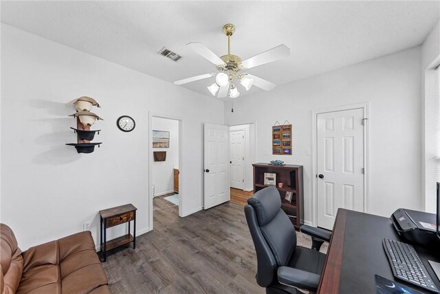 office space featuring ceiling fan and dark hardwood / wood-style flooring