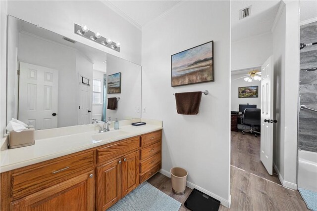 bathroom with vanity, hardwood / wood-style flooring, ceiling fan, and crown molding