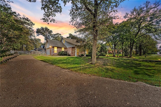 view of front of property with a yard and a garage