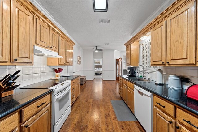 kitchen featuring dark hardwood / wood-style flooring, sink, white appliances, and ornamental molding