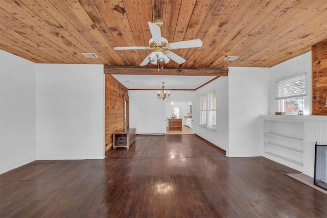 unfurnished living room with wooden walls, dark hardwood / wood-style floors, and a healthy amount of sunlight