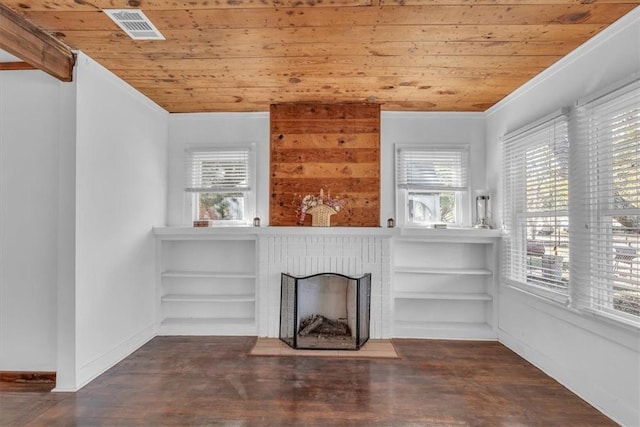 unfurnished living room with dark hardwood / wood-style floors, wood ceiling, a wealth of natural light, and a brick fireplace