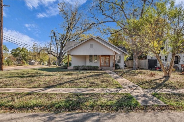 bungalow-style house with a front lawn and covered porch