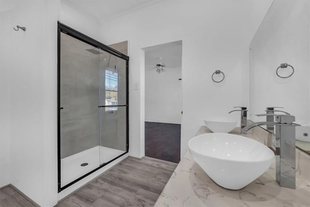 bathroom featuring ceiling fan, hardwood / wood-style floors, vanity, and walk in shower