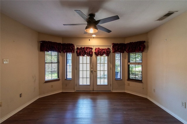 unfurnished room featuring ceiling fan, dark hardwood / wood-style flooring, and french doors