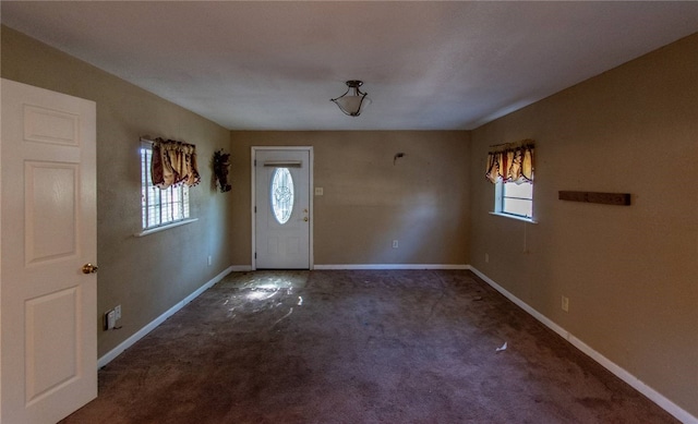 entryway with dark carpet