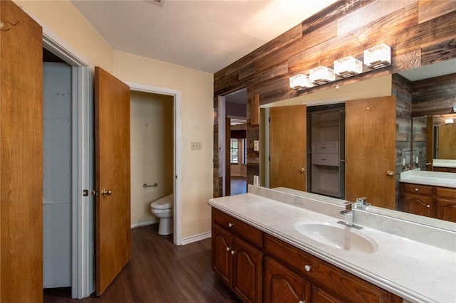 bathroom with hardwood / wood-style floors, vanity, and toilet