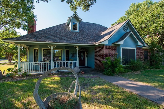 view of front of home with a front yard and covered porch