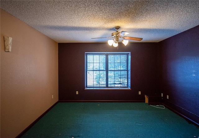 empty room with carpet flooring, ceiling fan, and a textured ceiling