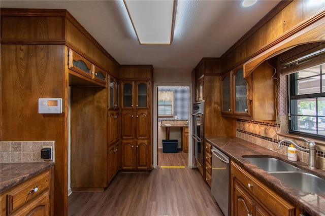 kitchen featuring dark hardwood / wood-style floors, tasteful backsplash, sink, and stainless steel appliances