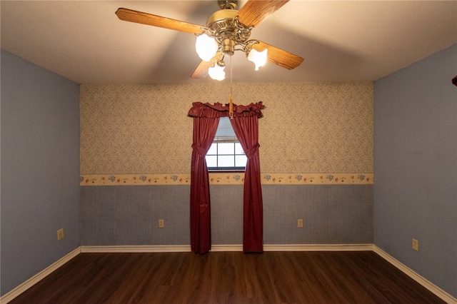 spare room with dark hardwood / wood-style floors and ceiling fan