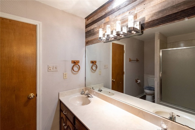 bathroom featuring vanity, toilet, and walk in shower