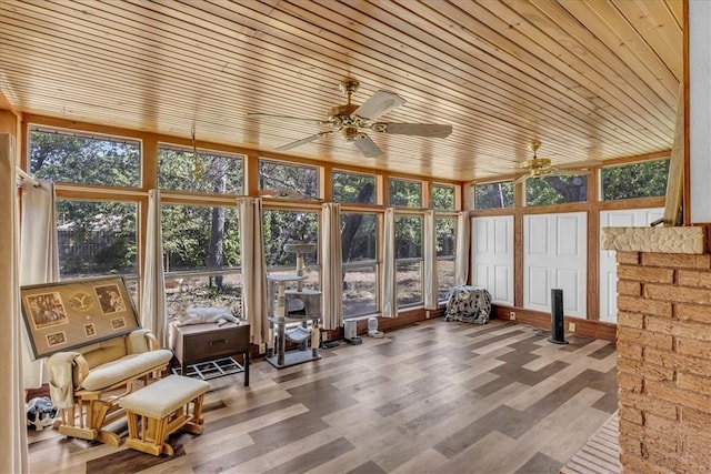 unfurnished sunroom with ceiling fan and wood ceiling