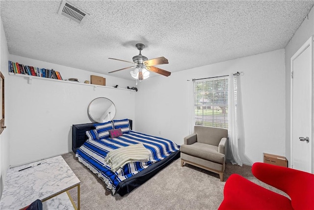 bedroom with carpet, ceiling fan, and a textured ceiling