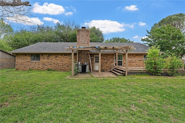 rear view of property with a pergola, a yard, and a deck