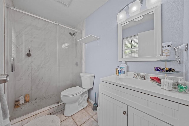 bathroom featuring toilet, vanity, tile patterned floors, and a shower with door