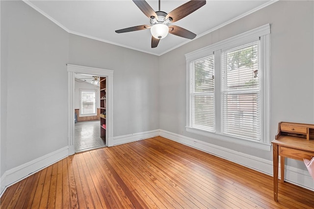 unfurnished room with hardwood / wood-style flooring, ceiling fan, and ornamental molding