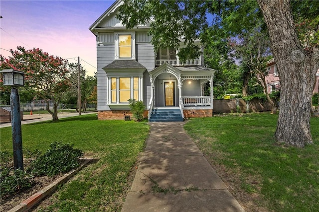 view of front facade with a yard and covered porch