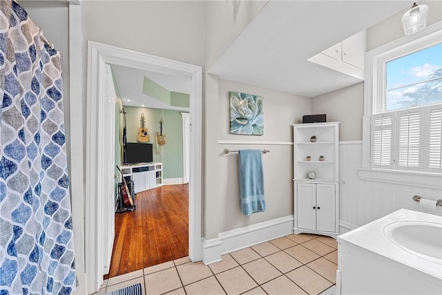 bathroom with tile patterned flooring, vanity, and curtained shower