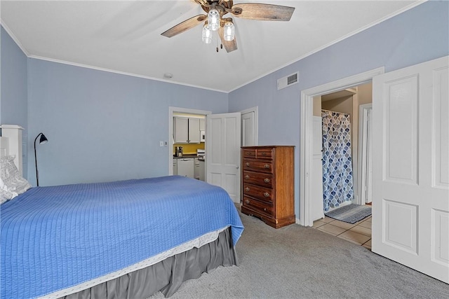 carpeted bedroom with ensuite bathroom, ceiling fan, and ornamental molding