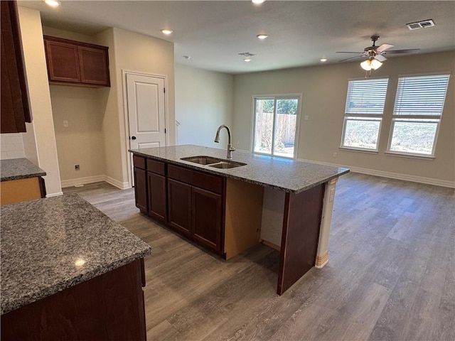 bathroom featuring vaulted ceiling, wood finished floors, toilet, and baseboards