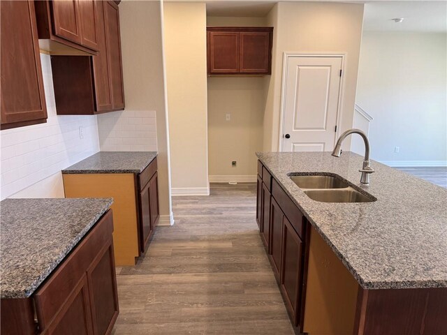 corridor featuring light carpet, attic access, baseboards, and an upstairs landing