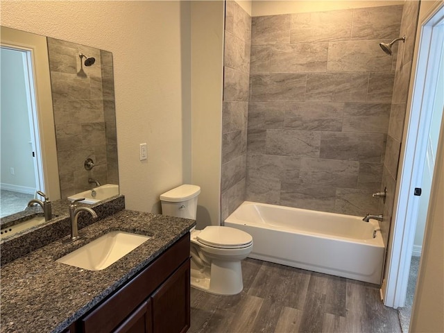 full bathroom featuring bathtub / shower combination, vanity, toilet, and wood finished floors