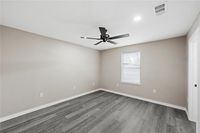 spare room with ceiling fan and dark hardwood / wood-style floors