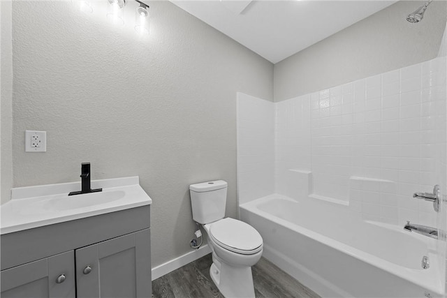 full bathroom featuring hardwood / wood-style flooring, vanity,  shower combination, and toilet