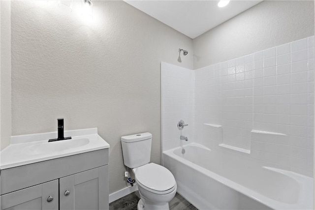 full bathroom with vanity, hardwood / wood-style flooring, shower / tub combination, and toilet