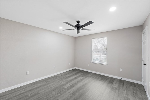 empty room featuring dark hardwood / wood-style floors and ceiling fan