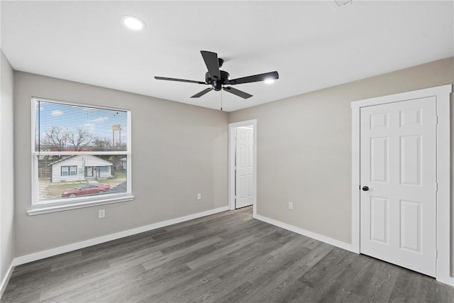 spare room featuring dark hardwood / wood-style floors and ceiling fan