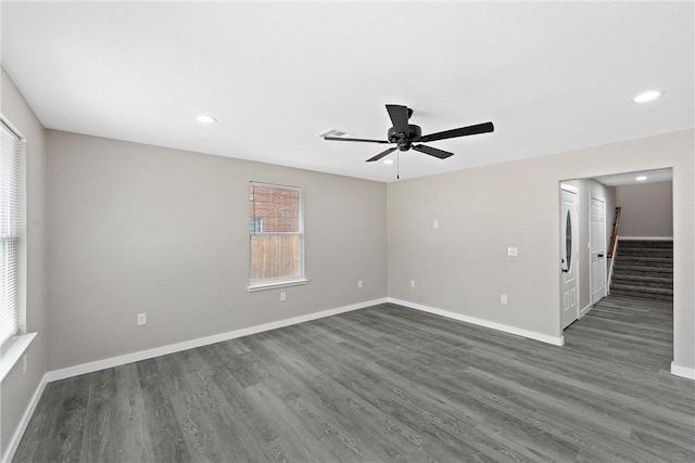 spare room featuring ceiling fan and dark hardwood / wood-style floors