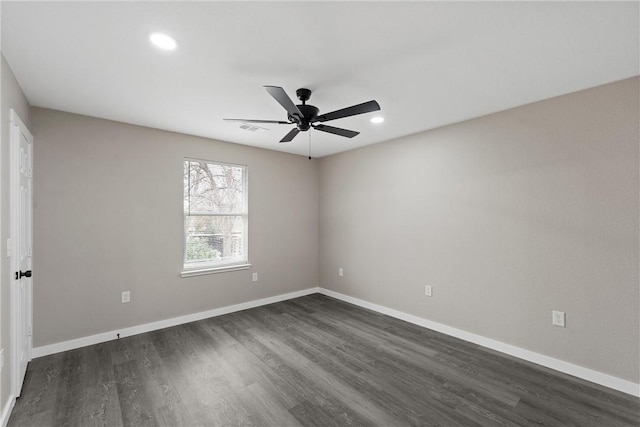 unfurnished room featuring ceiling fan and dark hardwood / wood-style flooring