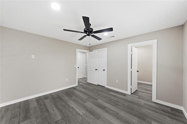 unfurnished bedroom with ceiling fan and dark hardwood / wood-style flooring