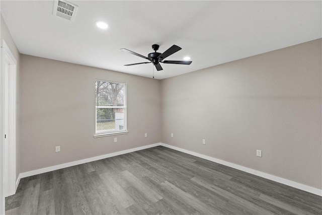 empty room featuring dark wood-type flooring and ceiling fan