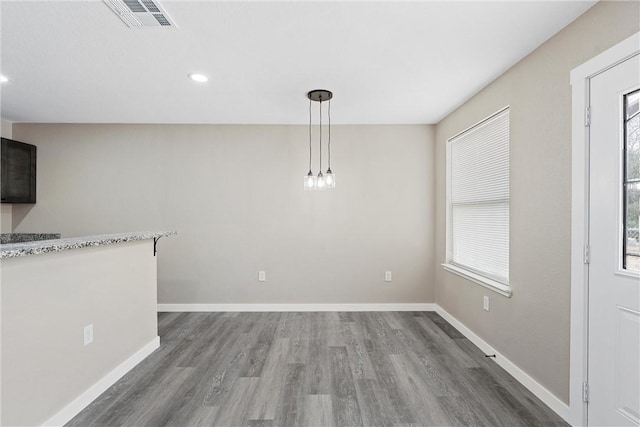 unfurnished dining area with dark hardwood / wood-style flooring