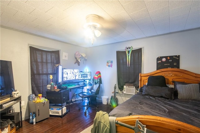 bedroom featuring ceiling fan, cooling unit, and dark hardwood / wood-style floors