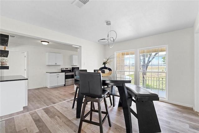 dining area with light hardwood / wood-style flooring