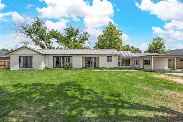 view of front of house with a front lawn and a carport