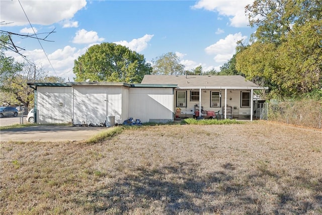 rear view of property featuring a yard