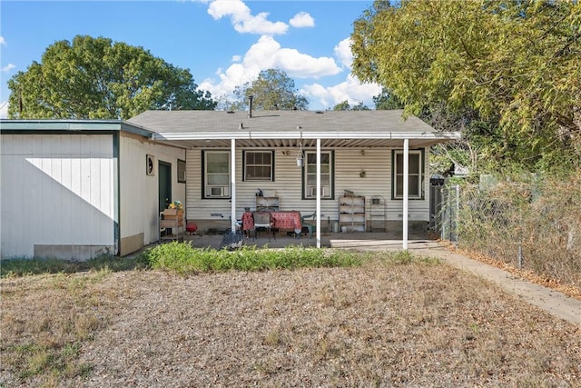 rear view of property featuring cooling unit