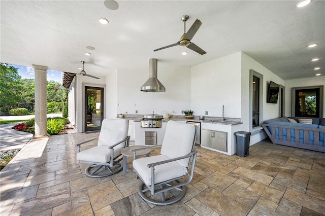 view of patio with area for grilling and ceiling fan