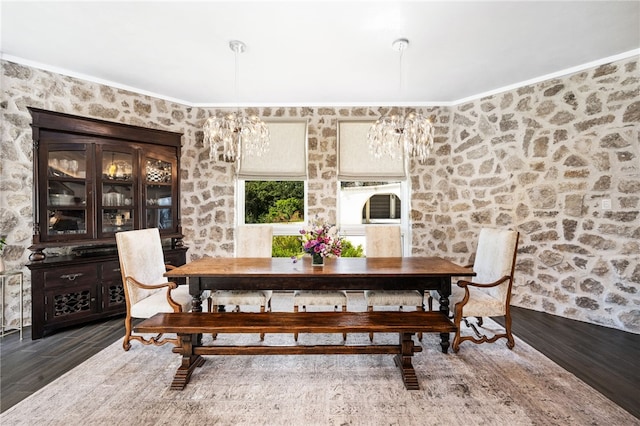 dining space featuring dark hardwood / wood-style floors and an inviting chandelier