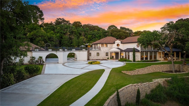 mediterranean / spanish home with a lawn