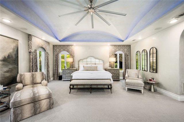 carpeted bedroom featuring a raised ceiling, ceiling fan, and lofted ceiling