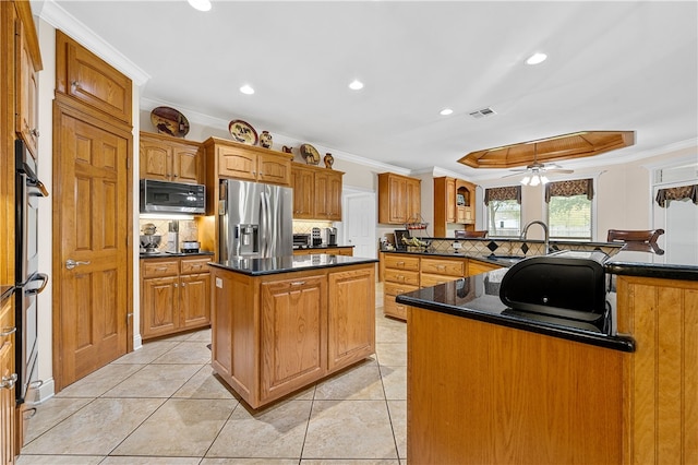 kitchen with a center island, sink, ornamental molding, and stainless steel appliances